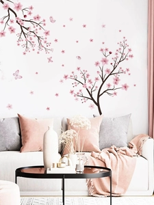 Close-up of pink cherry blossom wall stickers with butterflies on a white living room wall