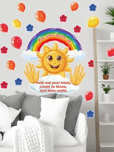 Detail of sun and rainbow wall stickers on a white wall above a fabric sofa