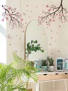 Detail of pink cherry blossom wall decals with butterflies above a white dressing table