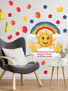 Detail of sun and rainbow PVC wall stickers with motivational quotes in a modern nursery