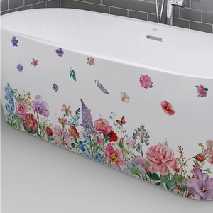 Colorful watercolor floral and butterfly wall decals on a white bathtub surface