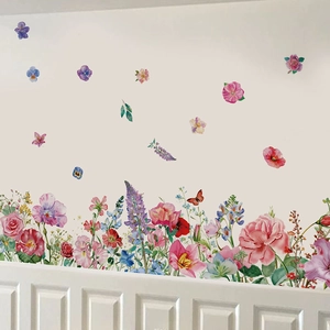 Vibrant watercolor wildflower and butterfly wall decals on a white home hallway background