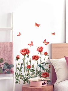Detailed view of red rose and butterfly PVC wall stickers on a bedroom wall background