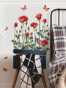Close-up of PVC red rose flower wall stickers with green leaves and butterflies on a white wall