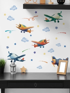 Detailed view of watercolor cartoon planes and clouds wall stickers in a cozy room setting