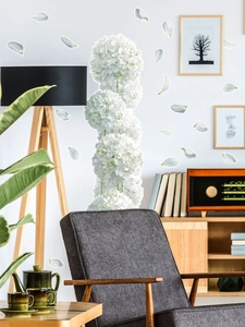 Detailed view of white hydrangea wall stickers in a cozy minimalist living room setting