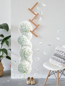 Detail of white hydrangea wall decals with wood geometric branch in a Nordic room