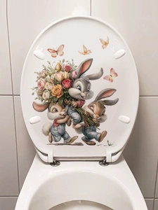 Close-up of cute cartoon rabbits and flower bouquet decal on a white U-shaped toilet lid