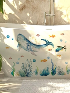 Detailed watercolor whale and sea turtle stickers applied on a white bathtub in a bathroom