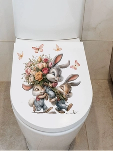 Close-up of Easter rabbit and flower PVC wall stickers applied to a white toilet lid cover