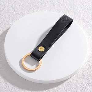 Detailed view of black lychee grain PU leather keychain strap with golden metal ring