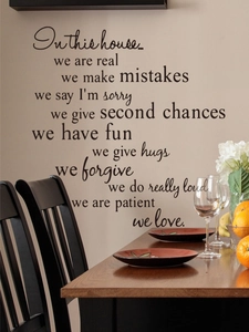 Detail of black vinyl wall decal with inspirational quotes in a cozy dining room