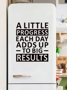 Close-up of black vinyl wall sticker with motivational quote on a white background