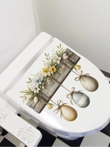 Detail of Easter floral wall decal with daffodils and eggs on a white toilet cover surface