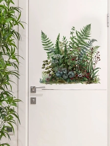 Détail d'autocollant mural de plantes vertes avec fleurs sur une porte intérieure blanche