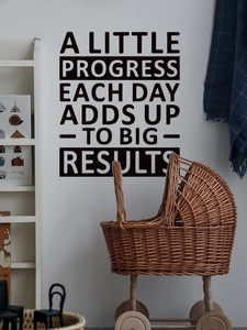 Macro shot of black vinyl wall sticker with motivational text on white minimalist wall
