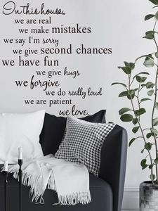 Detail of black vinyl wall decal with inspirational family quotes in a modern living room