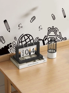 Detail of minimalist black wooden flip calendar with white pages on wooden desk