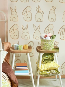 Detail of hand-drawn Easter bunny wall decals in a warm minimalist bedroom setting