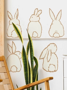 Minimalist brown Easter bunny wall decals showing five cute silhouettes on a white wall