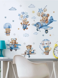 Nursery wall sticker with pilot bear flying a plane and hot air balloons on white wall