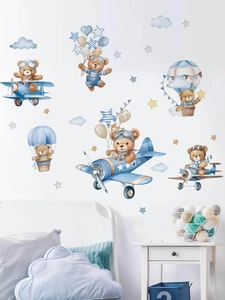 Detailed view of pilot teddy bear wall stickers in a cozy blue nursery setting