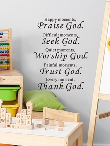 Close-up of black PVC religious wall decals with inspirational lettering on a grey wall