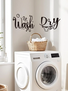 Detail of black PVC wall decals featuring Wash and Dry words with laundry icons for laundry room