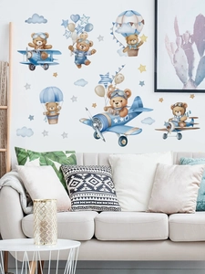 Detailed wall sticker featuring pilot bear in blue airplane with stars and clouds