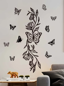 Detailed view of black butterfly and floral wall decals on a modern interior wall