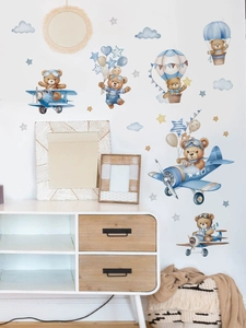 Nursery wall decal detail showing watercolor teddy bear flying a blue propeller airplane