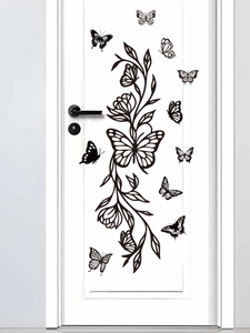 Close-up of black butterfly and floral vine wall stickers on a minimalist white door
