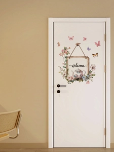 Detail of floral butterfly door sticker with Welcome text on a white door in a bedroom