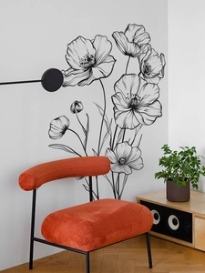 Detail of minimalist black line art flower wall sticker in a modern living room setup