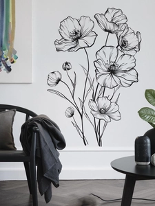 Minimalist black line art poppy flower wall sticker in a modern white bedroom setting