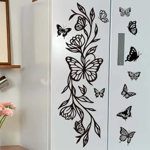 Elegant black butterfly and floral vine PVC wall stickers for home decor on white surface