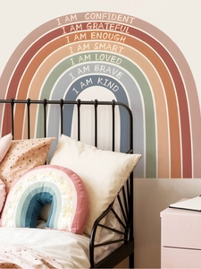 Macro detail of rainbow wall decals with white inspirational affirmations for kids room