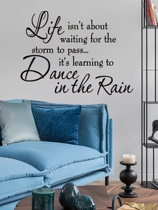 Close-up of inspirational quote wall decal on a modern living room background wall
