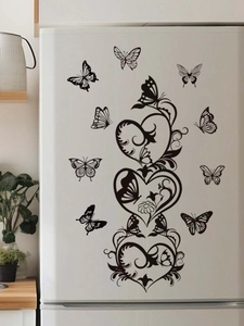 Detail of black butterfly and heart PVC wall stickers applied on a clean white refrigerator