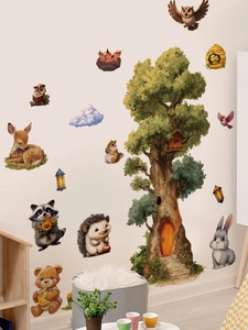 Detail of forest animal wall stickers featuring a tree house and woodland creatures for nursery
