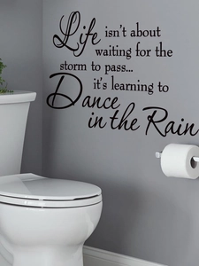 Detail of black vinyl wall sticker with inspirational English quotes on a bathroom wall