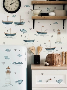Detail of nautical PVC wall stickers with sailboats, lighthouses and fish in kitchen