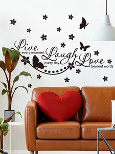 Detail of black PVC wall decals with Live Laugh Love quotes and butterfly floral patterns