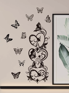 Detail of black butterfly and heart vine PVC wall stickers on a minimalist interior wall
