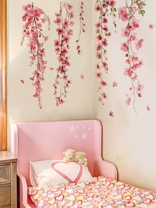 Pink floral vine wall stickers displayed above a cozy bed in a modern bedroom setting