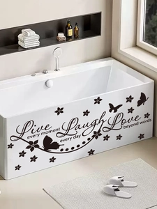 Detail of black vinyl wall stickers featuring quote and butterflies on bathroom surface