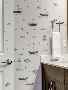 Detail of nautical wall stickers with sailboats and lighthouses in a bathroom setting