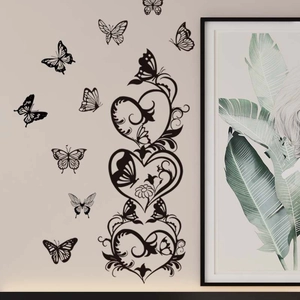Elegant black butterfly wall stickers with heart vine pattern on a beige living room wall