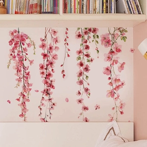Pink watercolor flower wall stickers showing hanging cherry blossom branches in a bedroom