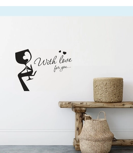 Modern black wine glass wall decal with elegant cursive lettering on a white kitchen wall